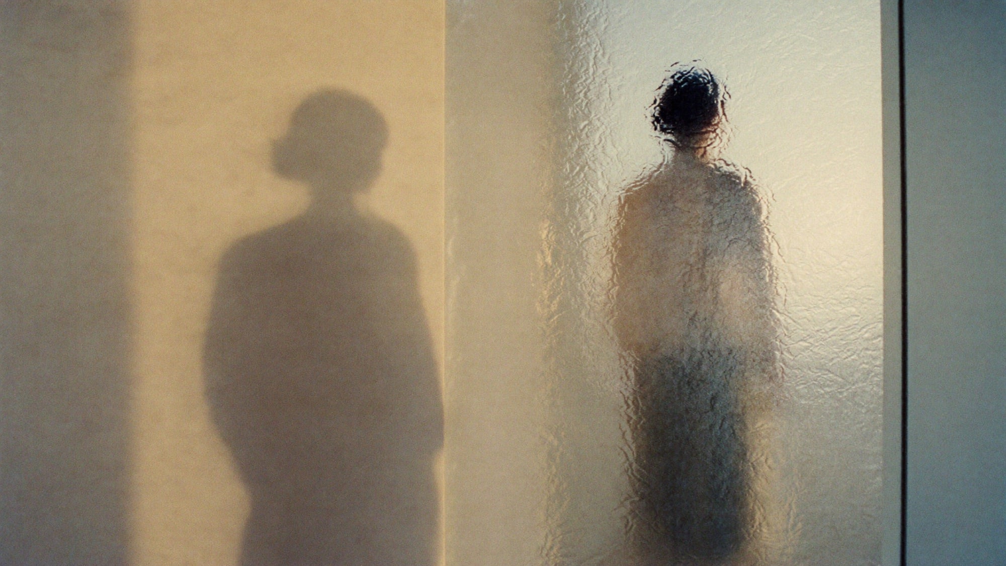 Figure behind frosted glass
